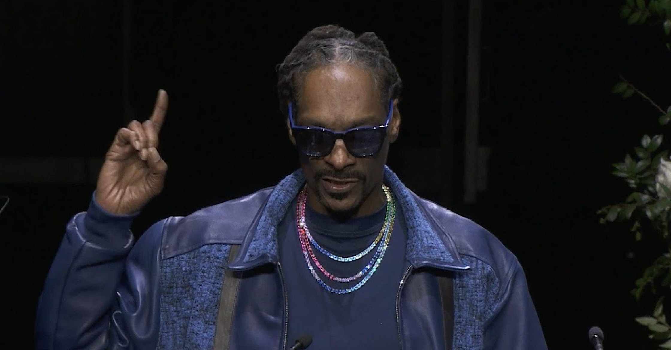 Snoop Dogg wearing an off-white hooded bench coat at Swansea.com Stadium during the EFL Championship match between Swansea City and Preston North End, standing pitchside in a relaxed sideline look.