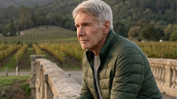 Shrinking Season 3 star Harrison Ford wears a stylish olive green puffer jacket, adding a pop of color to the screen.