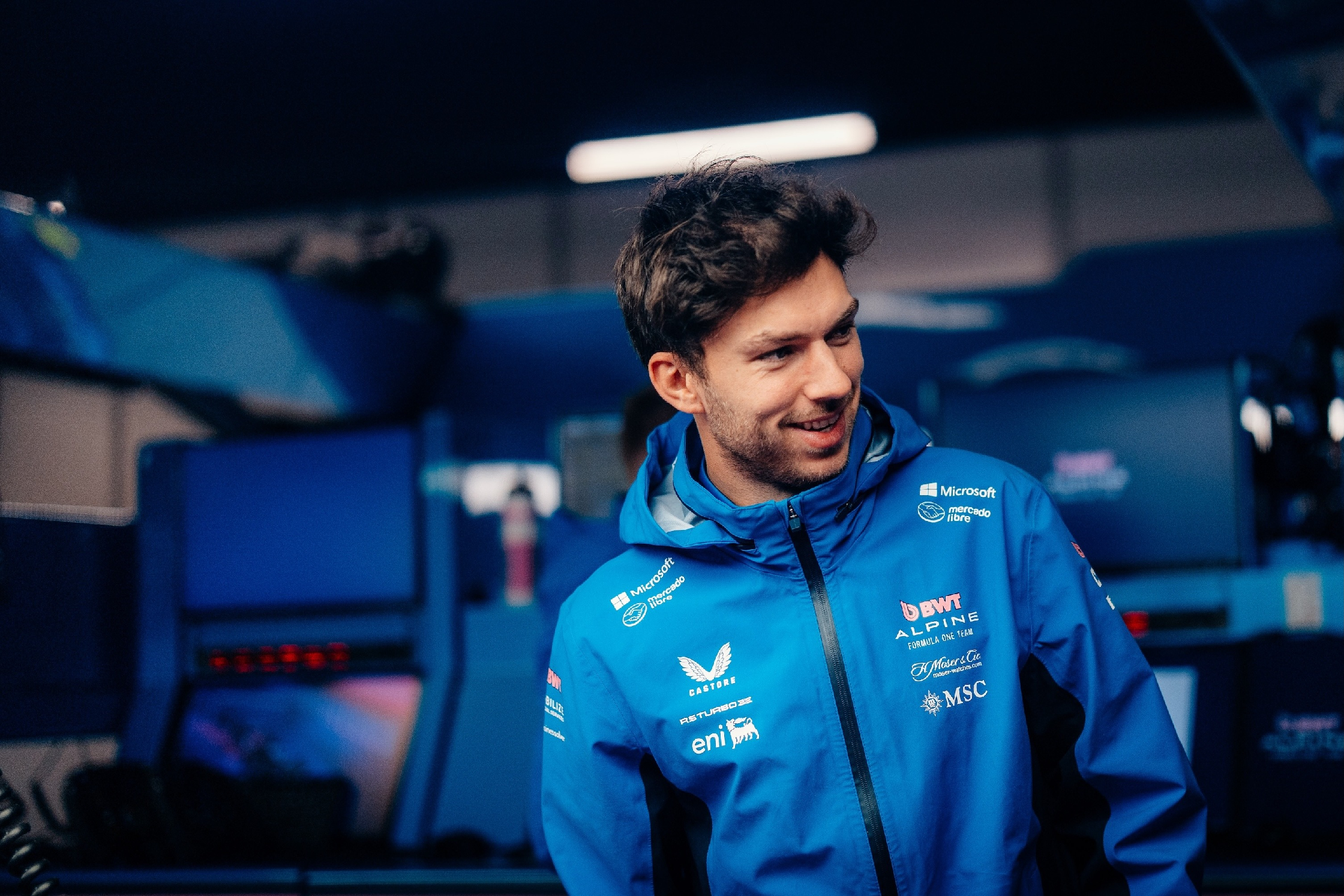 Pierre Gasly Belgium F1 BWT Alpine Blue Jacket – Official Alpine F1 Team waterproof hooded racing jacket with black side panels, full-length zipper, and team logos on chest and shoulders