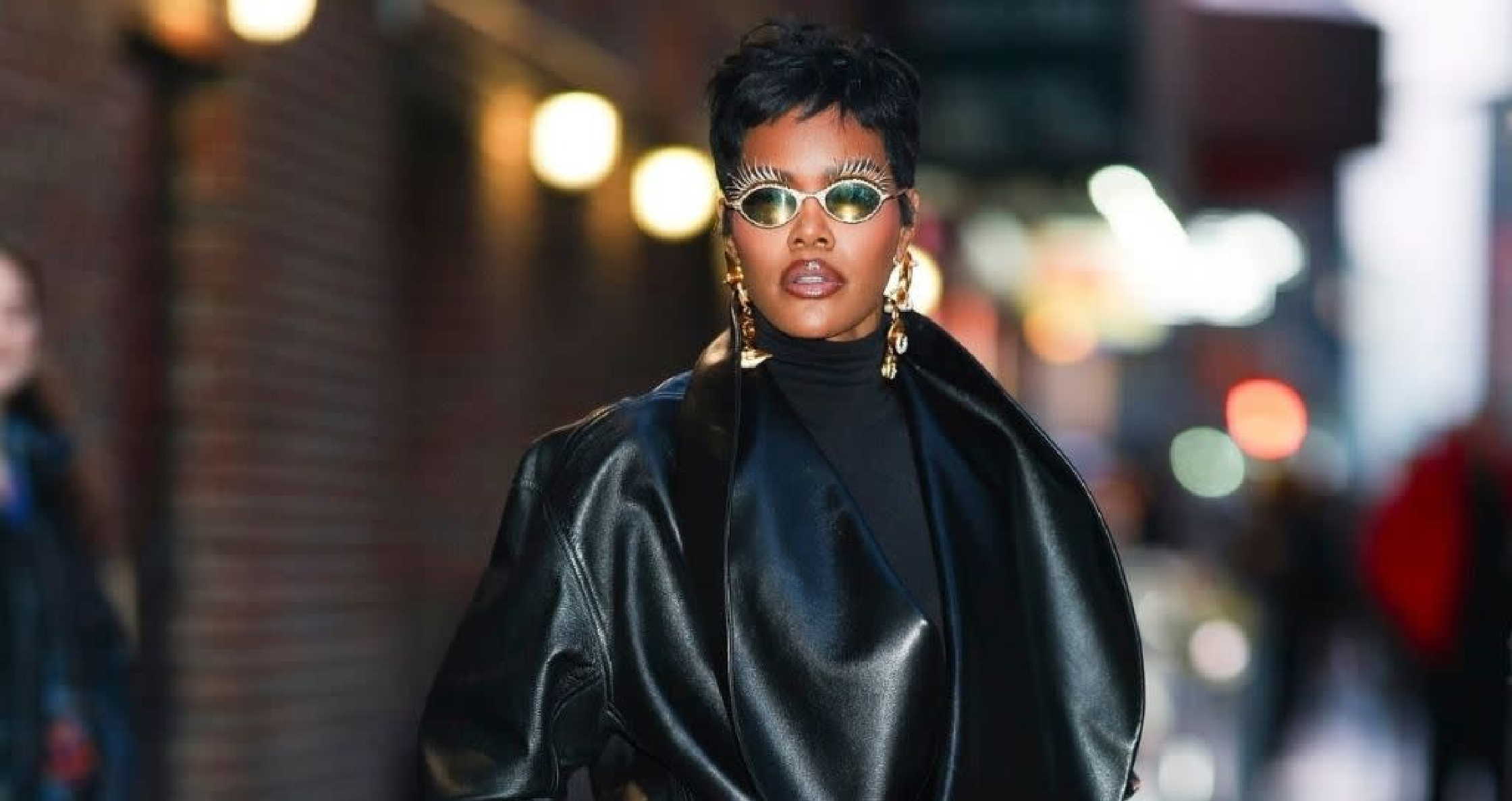 Teyana Taylor wearing the NYC 2026 black leather jacket with oversized shawl collar on The Late Show With Stephen Colbert, blending edgy streetwear and avant-garde sophistication in New York City.