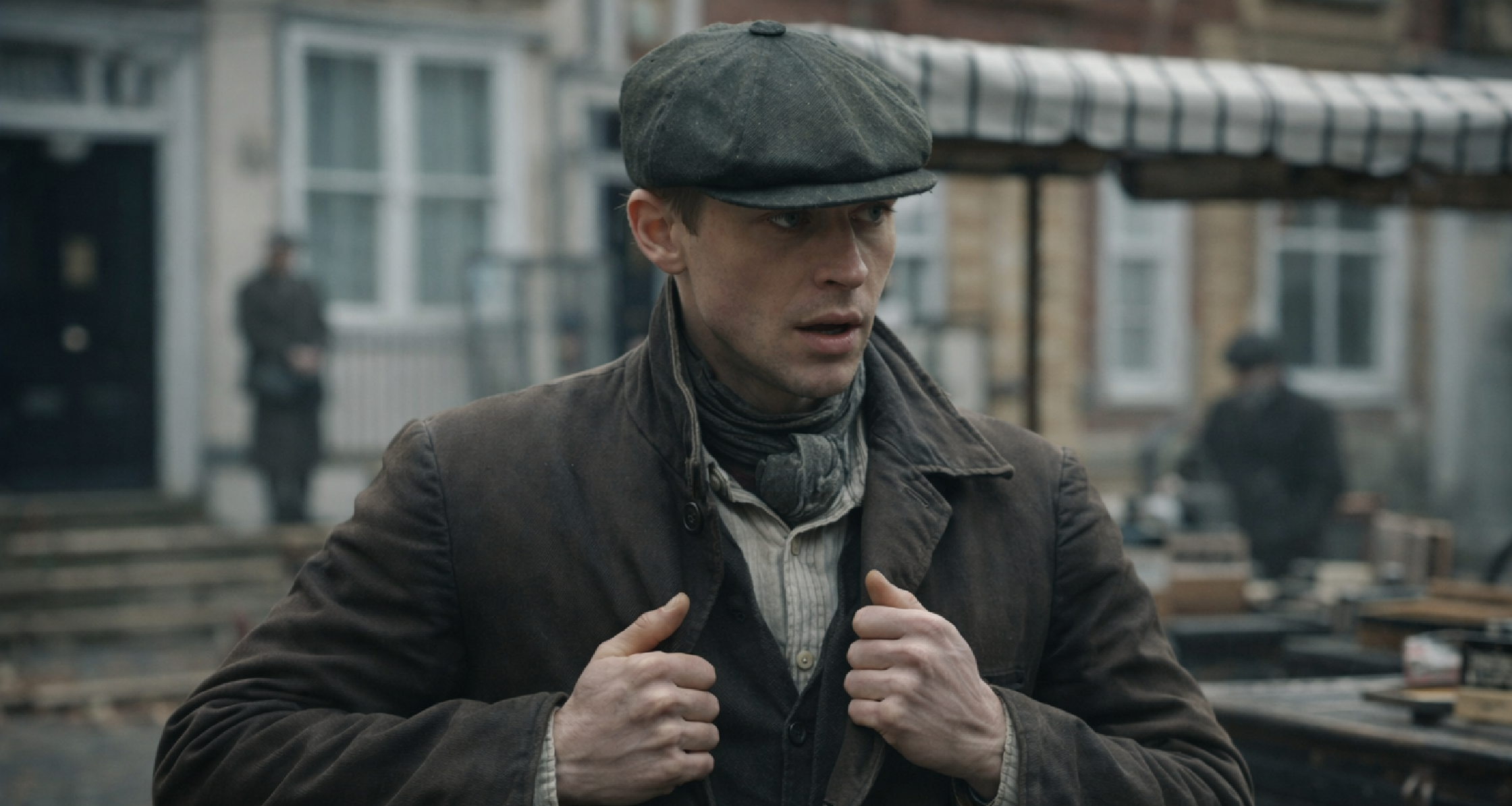 Young Sherlock Hero Fiennes Tiffin wearing distressed charcoal Prussian collar utility jacket