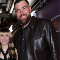 Travis Kelce wears a dark brown leather trucker jacket at the 2026 iHeartRadio Music Awards