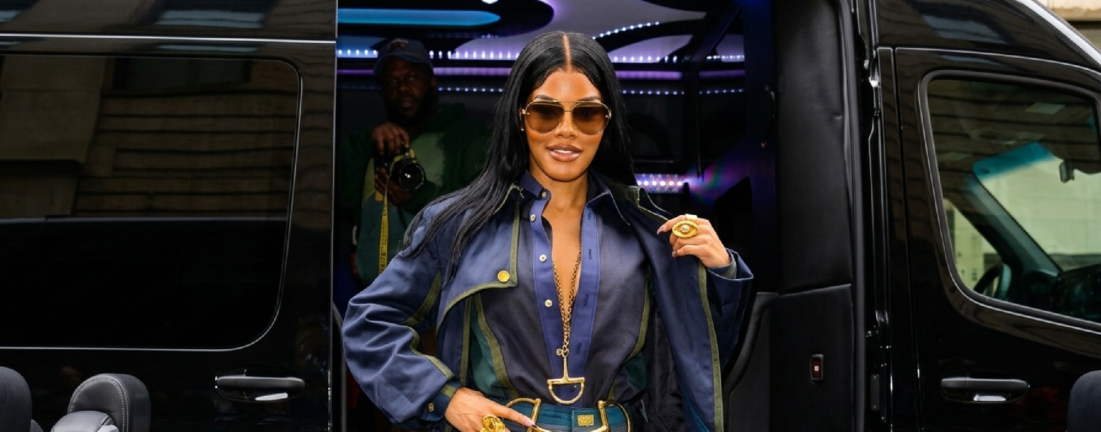 Teyana Taylor NYC 2025 midnight navy floor-length trench coat with gold horsebit buckle and olive contrast piping