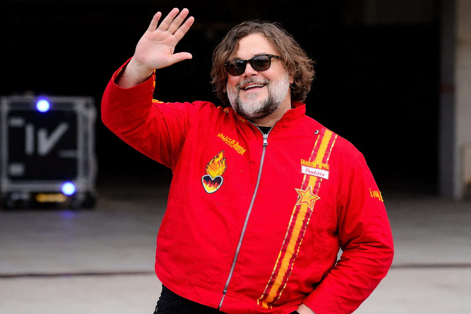 Jack Black F1 Japanese Grand Prix 2026 red racing jacket with Bowser patch, flame heart graphic, and distressed stripe design