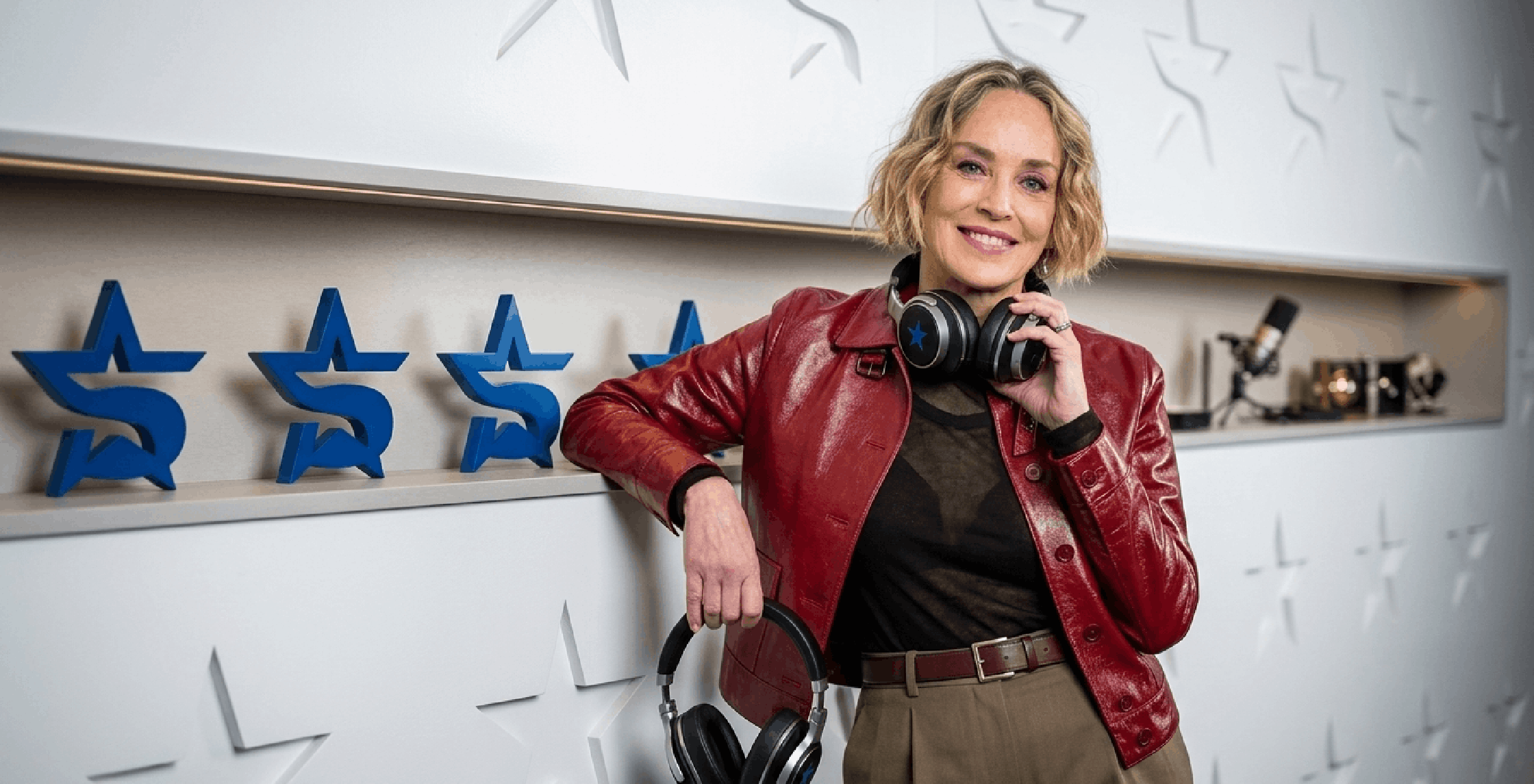 Sharon Stone wearing 2026 cherry red patent leather cropped jacket at SiriusXM Studios