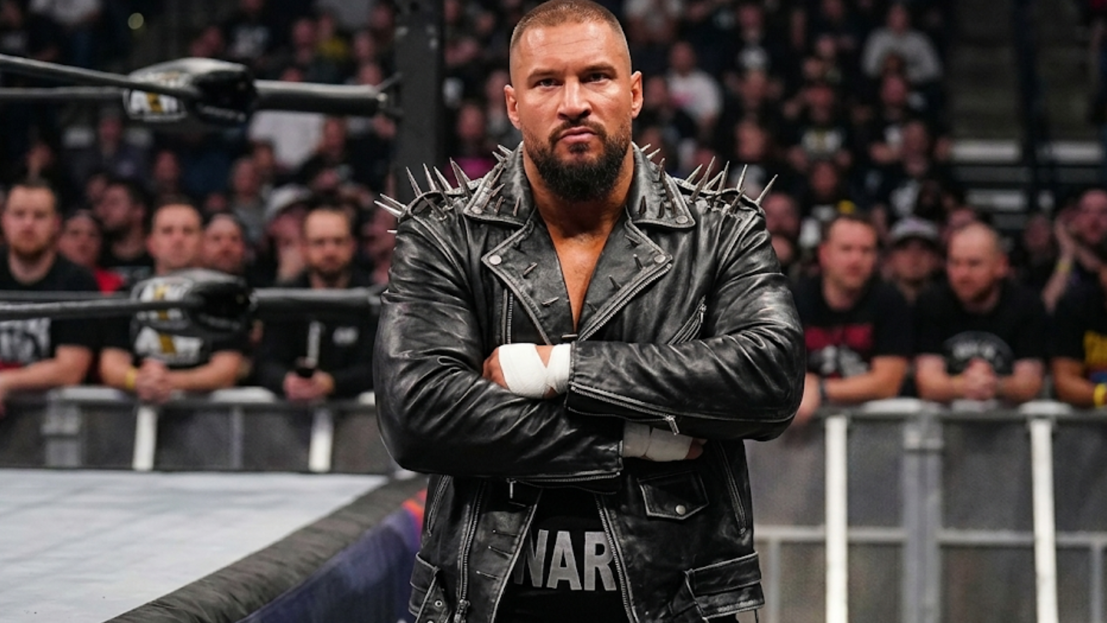 Bron Breakker WWE Survivor Series black asymmetrical biker leather jacket with silver spike epaulets and belted waist