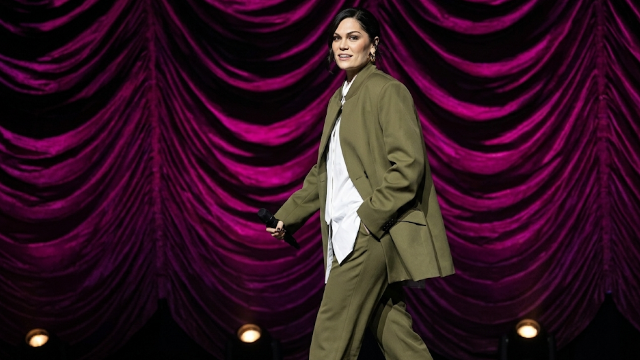 Jessie J London Palladium 2026 oversized olive green blazer with double-breasted front, mandarin collar, and structured padded shoulders