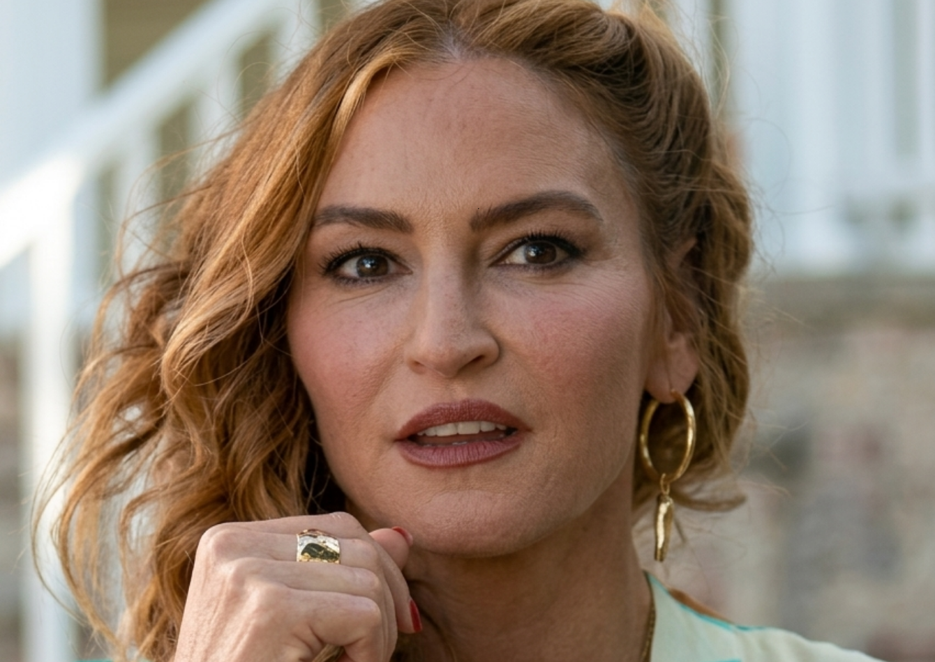 Drea de Matteo wearing Nonnas Stella’s Printed Satin Kimono in white with vibrant floral botanical print and kimono sleeves