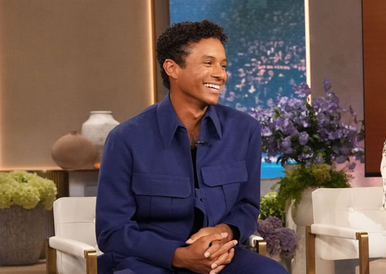Jaafar Jackson wearing a navy blue oversized cargo utility jacket with chest pockets and a buckled waist strap on The Jennifer Hudson Show Season 4