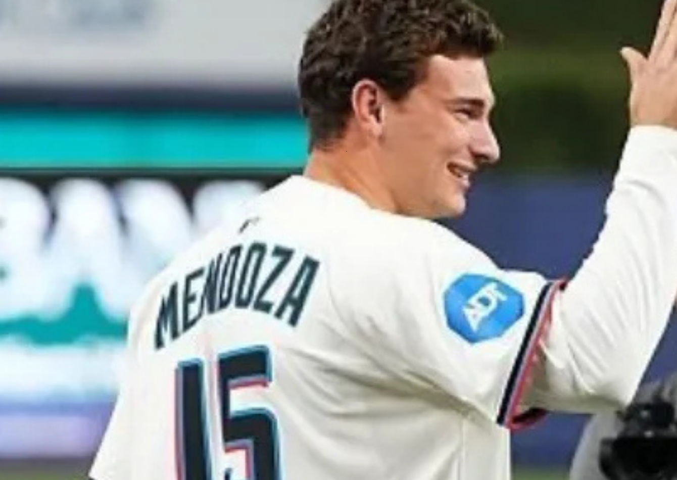 Fernando Mendoza wearing Miami Marlins City Connect jersey with “Miami” script front design and number 15 on the back during Cardinals vs Marlins game