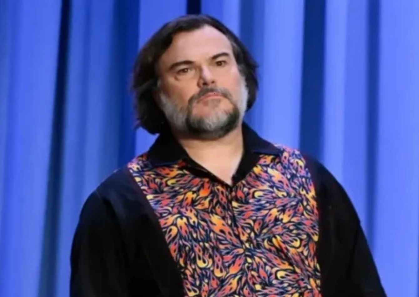 Jack Black wearing a bold black and multicolor flame paisley long-sleeve button-down shirt on The Tonight Show Starring Jimmy Fallon backstage Season 13 Episode 2277