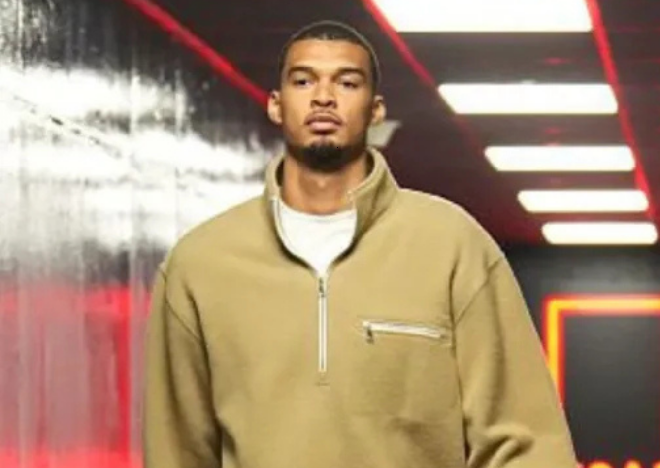 Victor Wembanyama wearing tan oversized quarter-zip fleece jacket with chest zip pocket during Spurs vs Trail Blazers playoff arrival