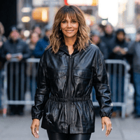 Halle Berry Crime 101 black leather jacket with funnel neck, smocked waist, and dolman sleeves in NYC cinematic style