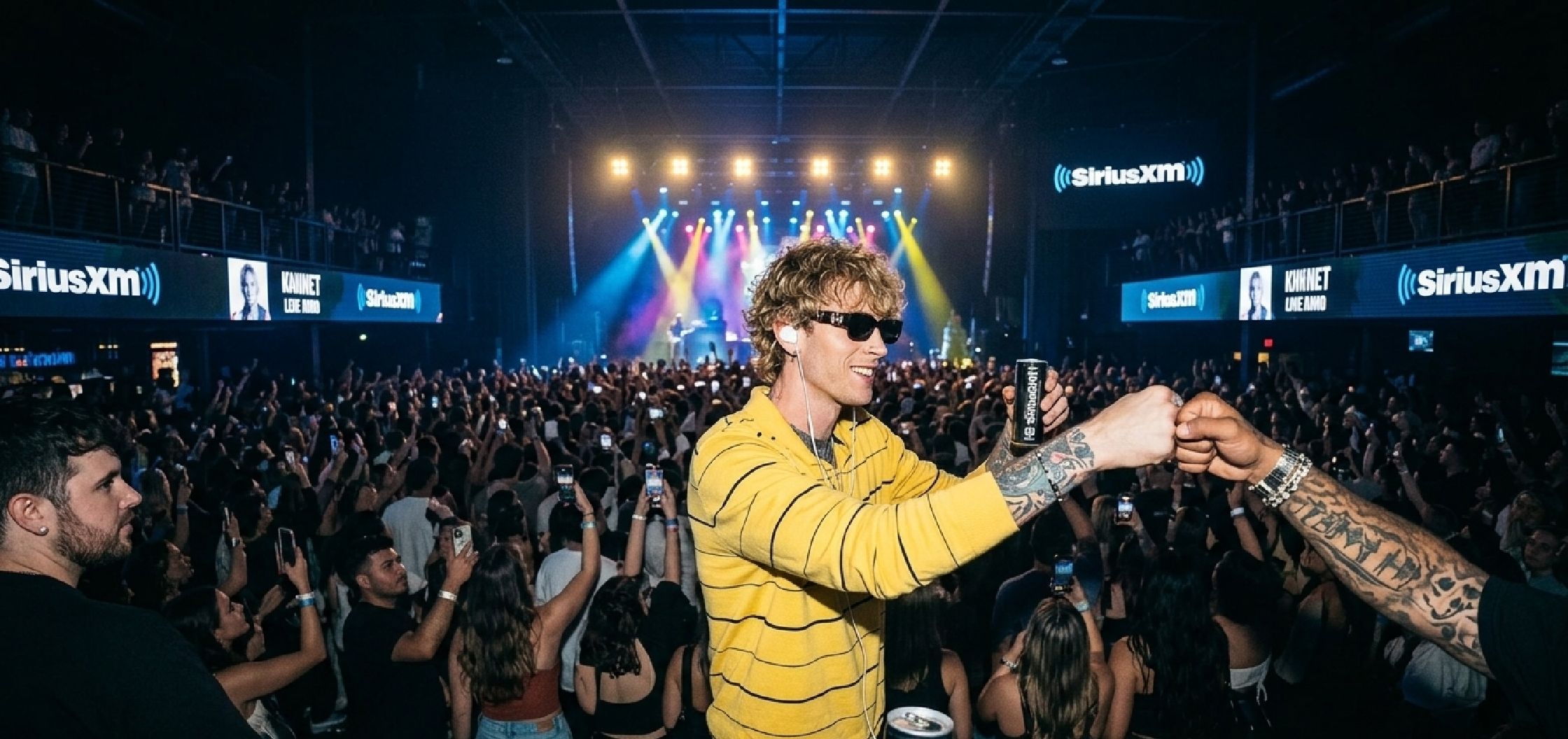 Machine Gun Kelly wearing The League yellow stripe sweatshirt with black horizontal stripes at a streetwear fashion event in Los Angeles