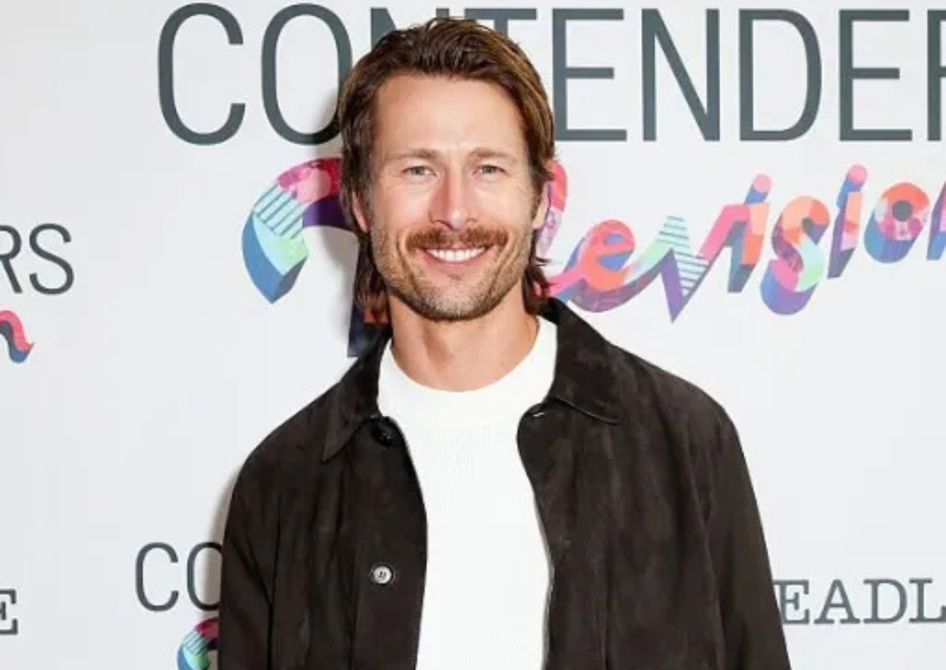 Glen Powell wearing a dark espresso brown suede jacket with a patch pocket and button front at Deadline Contenders Television 2026 event