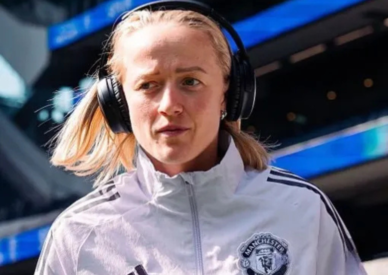 Lea Schuller wearing a lilac Manchester United Adidas training jacket with black panels and funnel neck at Tottenham Hotspur Stadium 2026