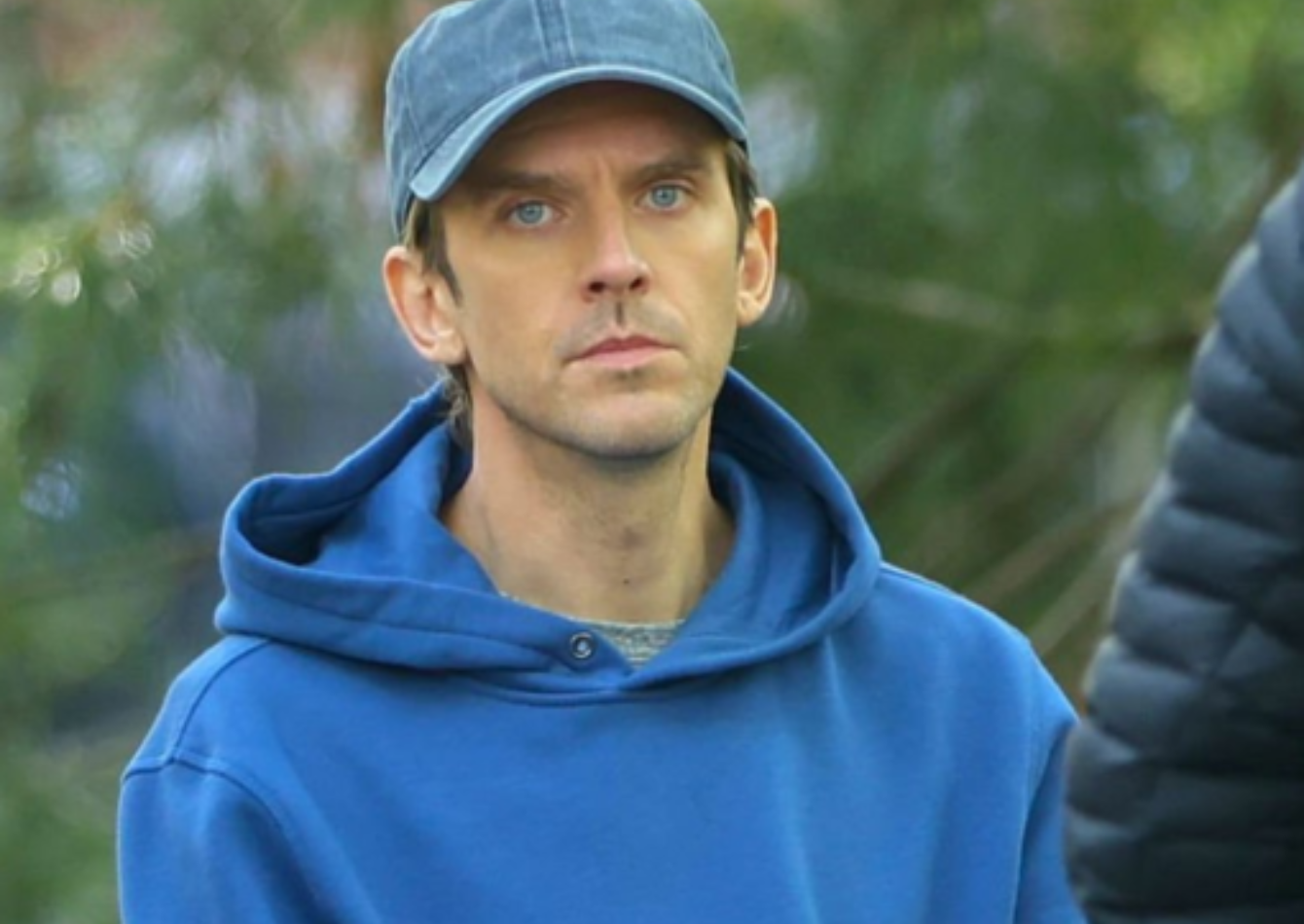 Dan Stevens wearing a royal blue crossover hood hoodie with kangaroo pocket on Dexter Resurrection 2026 set in NYC