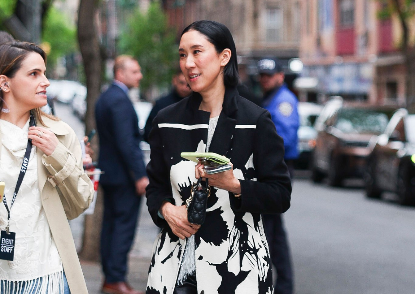 Eva Chen wearing a black and white monochrome longline trench coat with abstract floral patterns at The Devil Wears Prada 2 NYC 2026 screening