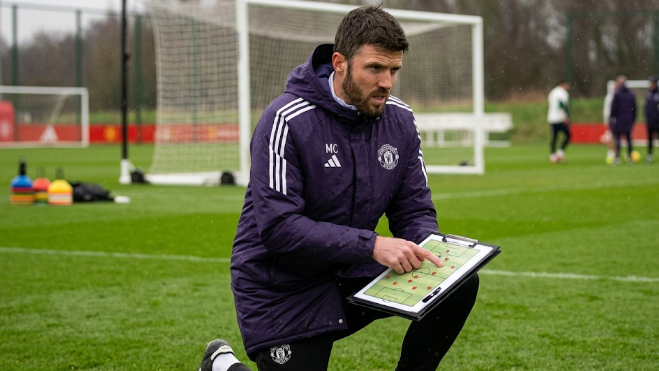 Michael Carrick Manchester United training session purple hooded coat with club crest and Adidas three-stripes sideline design
