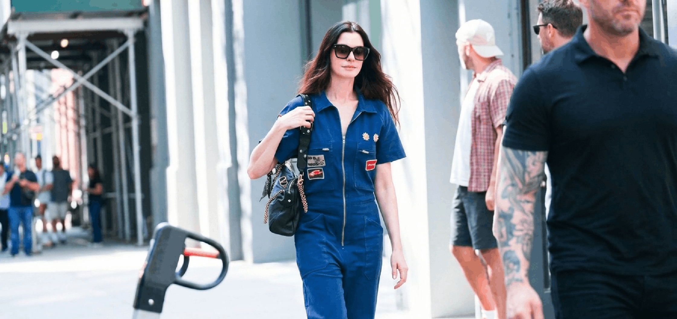 Anne Hathaway wearing a navy blue denim jumpsuit on the set of The Devil Wears Prada 2 in New York City, styled as cinematic luxury workwear