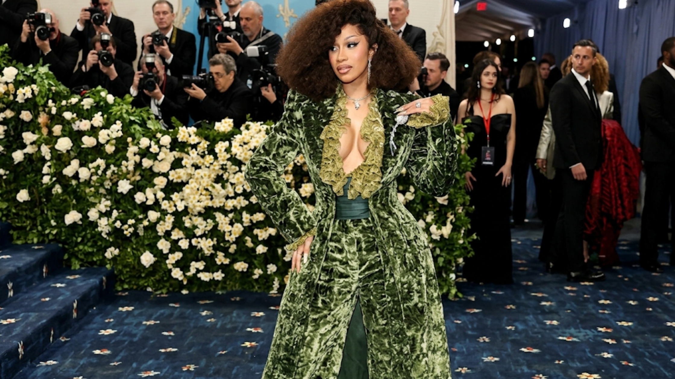 Cardi B Met Gala 2025 green long moss satin coat with ruffled lace collar, padded shoulders, and dramatic A-line silhouette