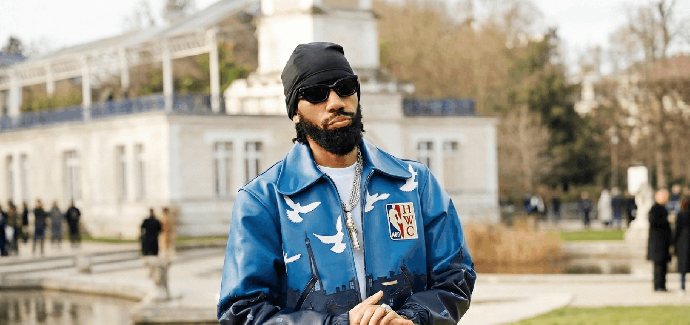 Phyno Paris Fashion Week navy leather bomber jacket with Paris skyline artwork, flying dove embroidery, NBA HWC patch, and luxury streetwear design details