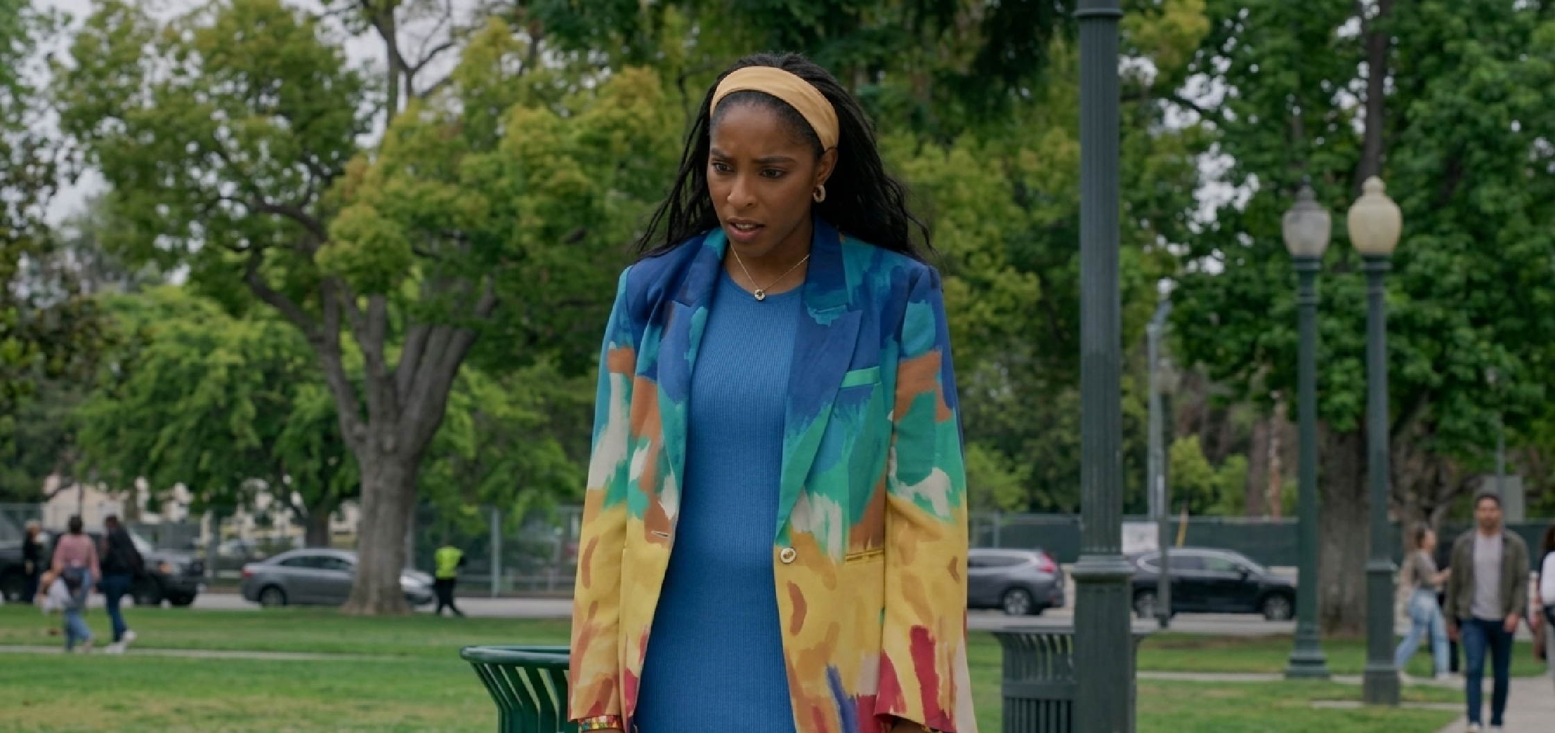 Jessica Williams wearing a multicolor abstract watercolor printed blazer in Shrinking Season 3 Episode 3 “D-Day,” featuring bold artistic patterns and tailored silhouette