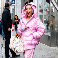 Doja Cat wearing a bubblegum pink oversized puffer hoodie jacket with matching track pants in Herald Square, NYC 2026 fashion look