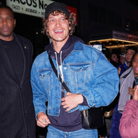 Connor Storrie NYC SNL after-party denim-on-denim outfit featuring oversized trucker jacket and hoodie street style look