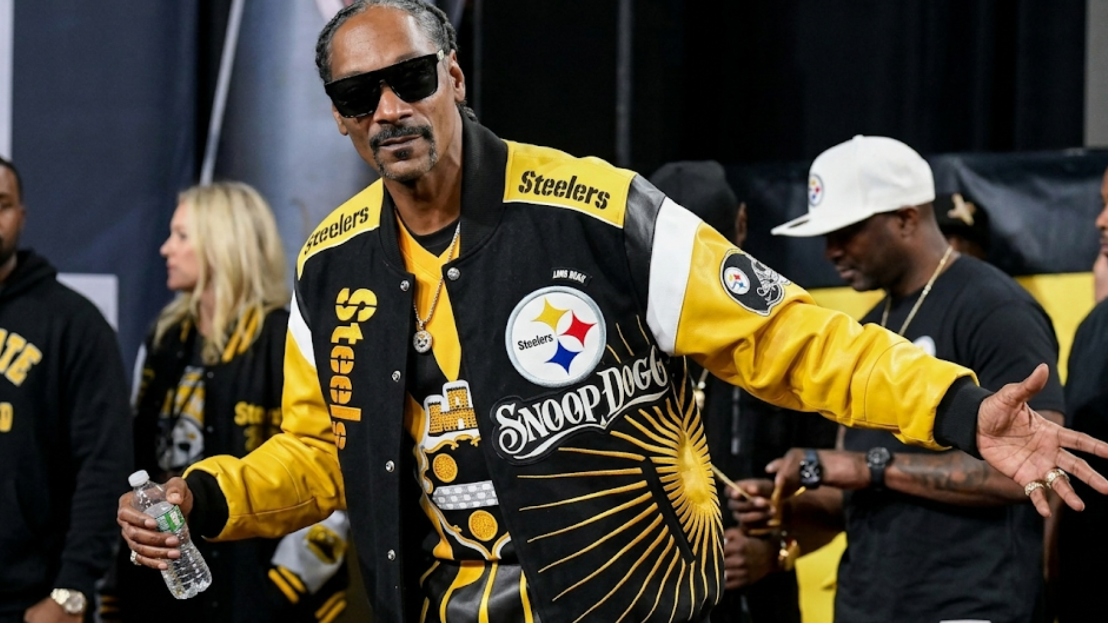 Snoop Dogg Pittsburgh Steelers black and gold leather jacket with embroidered logos, sunburst detailing, and white shoulder inserts
