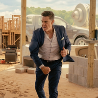 Chris Caldovino wearing a navy blue blazer with distressed sleeve detailing, layered shirt styling, and bold jewelry in Tulsa King Season 3