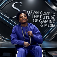 IShowSpeed wearing a royal blue oversized fleece sweatshirt with matching track pants featuring white side stripes at the 2025 Joy Forum in Riyadh during a “Stream to Mainstream” panel discussion alongside MrBeast and Terry Crews.