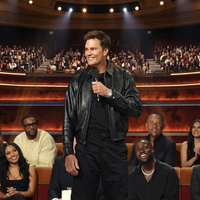 Tom Brady black leather Harrington-style jacket from Netflix Is A Joke Festival Roast of Kevin Hart, sleek monochrome celebrity outfit with silver zip and shirt collar.