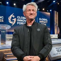 Sean Penn black bomber jacket from 17th Film Festival Lumière in Lyon, featuring matte finish, ribbed trims, chest patch detailing, and cinematic streetwear style.