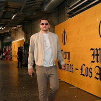 Luka Dončić Los Angeles Lakers beige suede bomber jacket with cream tone, silver zipper, ribbed collar and cuffs, minimalist courtside streetwear style.