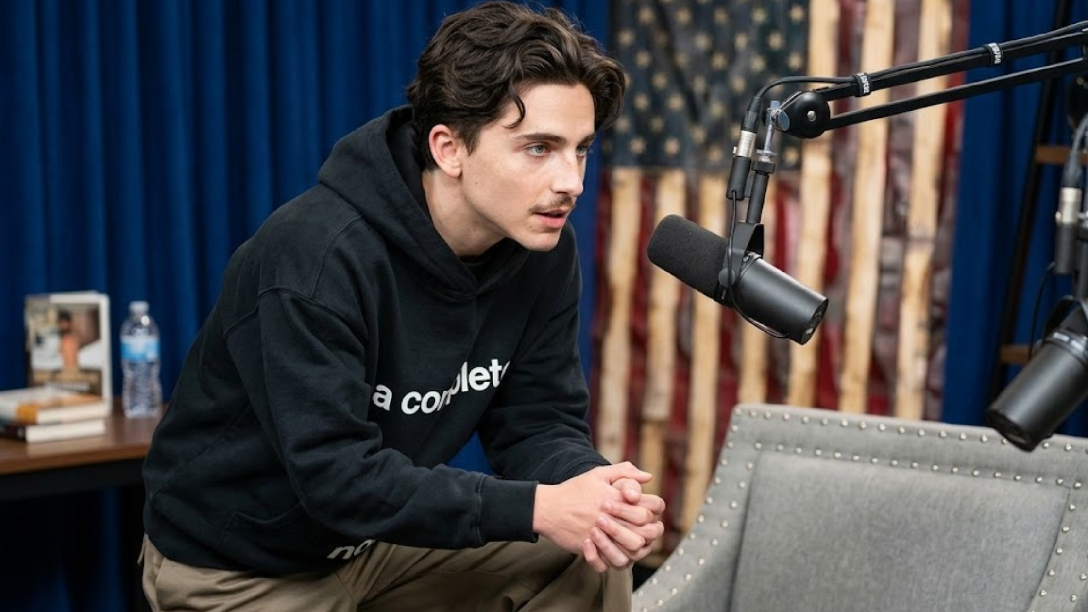 Timothée Chalamet A Complete Unknown black cropped boxy hoodie with white typography print and oversized fit streetwear