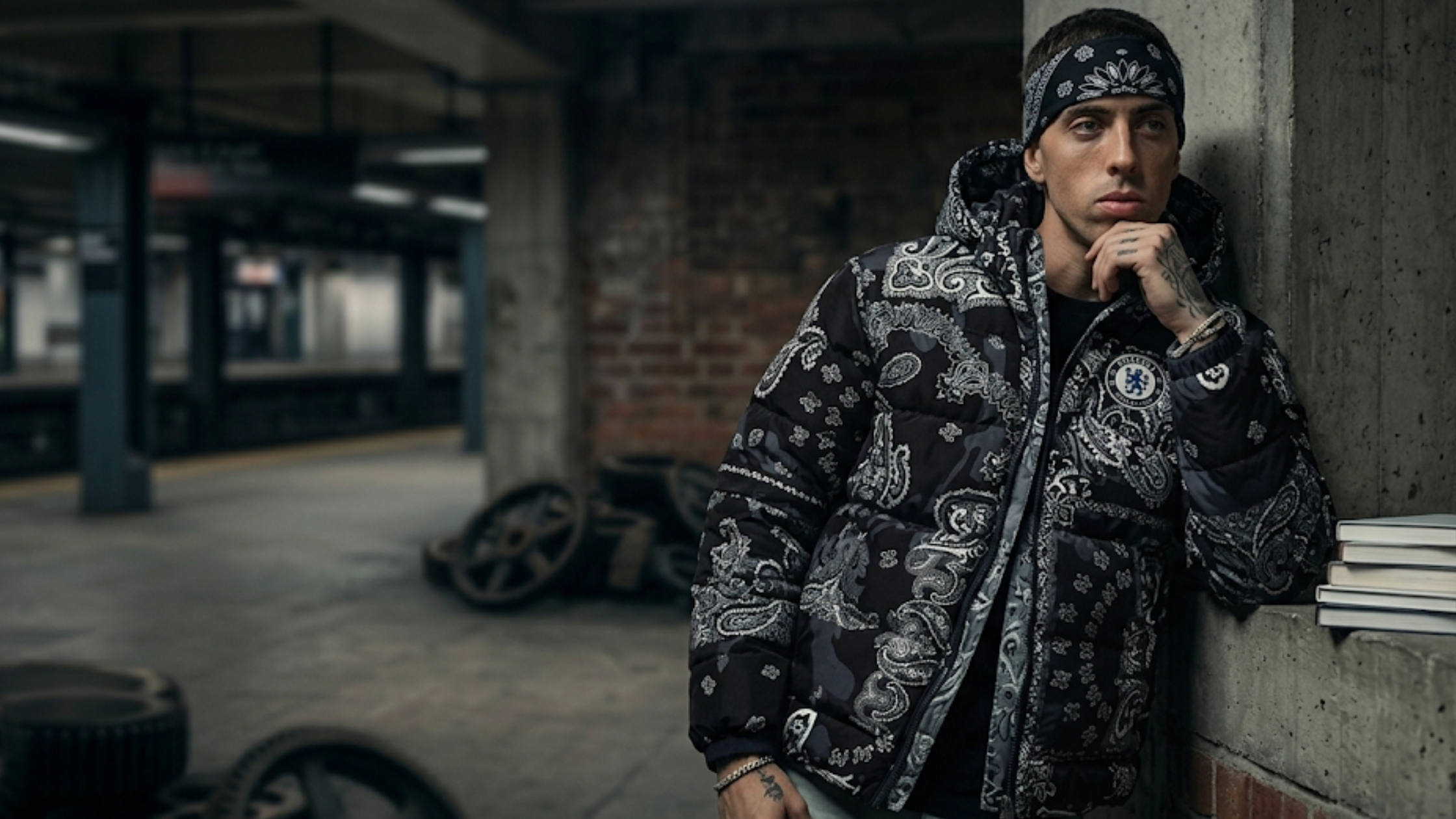 Central Cee black bomber jacket with acid wash finish, gothic ARTKRAFT chest print, WORLD TOUR graphic, and oversized streetwear fit