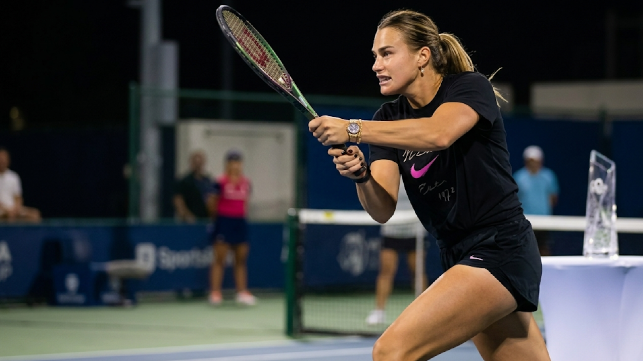 Aryna Sabalenka 2026 Miami Open black Nike t-shirt with white script logo, fuchsia Swoosh, and “Est. 1972” heritage graphic tennis sportswear tee