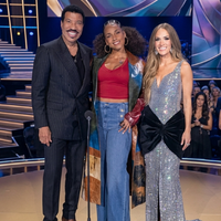 Alicia Keys wearing a floor-length ombre color block leather coat at American Idol 2026 Grand Finale performance stage look