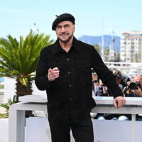 John Travolta Cannes 2026 black shirt jacket with patch pockets