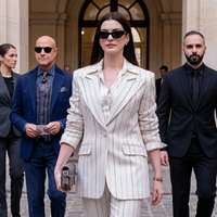 Anne Hathaway as Andy Sachs wearing a cream pinstripe blazer in The Devil Wears Prada 2 showcasing modern power dressing and luxury tailoring