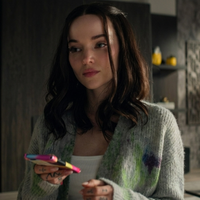 Ciara Wyse wearing an oversized grey tie-dye cardigan with abstract floral botanical print and cozy knit texture from 56 Days Season 1