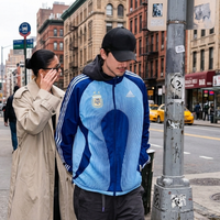 Timothée Chalamet Argentina navy and sky blue track jacket inspired by Adidas retro football style, styled as modern streetwear outfit.