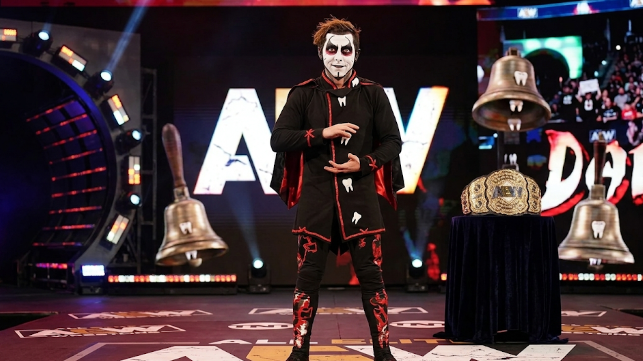 Danhausen SmackDown 2026 black asymmetrical tunic shirt with white tooth graphics red piping wrestling streetwear fashion