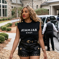 Drew Sidora wearing Balmain black muscle tee with bold white logo and gold shoulder buttons inspired by RHOA Season 16 Episode 9 luxury streetwear style