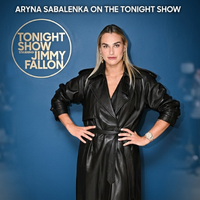 Aryna Sabalenka Tonight Show black leather trench coat with double-breasted front, waist belt, and long tailored silhouette