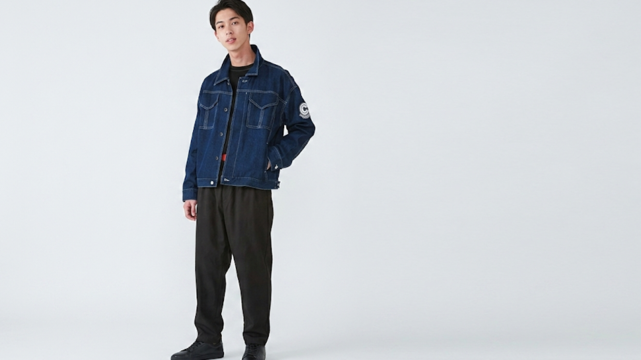 Future Trunks Dragon Ball Z blue cropped denim jacket with Capsule Corporation sleeve patch, chest pockets, contrast stitching, and metal button closure