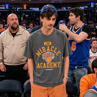 Timothée Chalamet MSG Knicks orange graphic shirt inspired by NBA courtside fashion with luxury streetwear aesthetic and Nahmias design