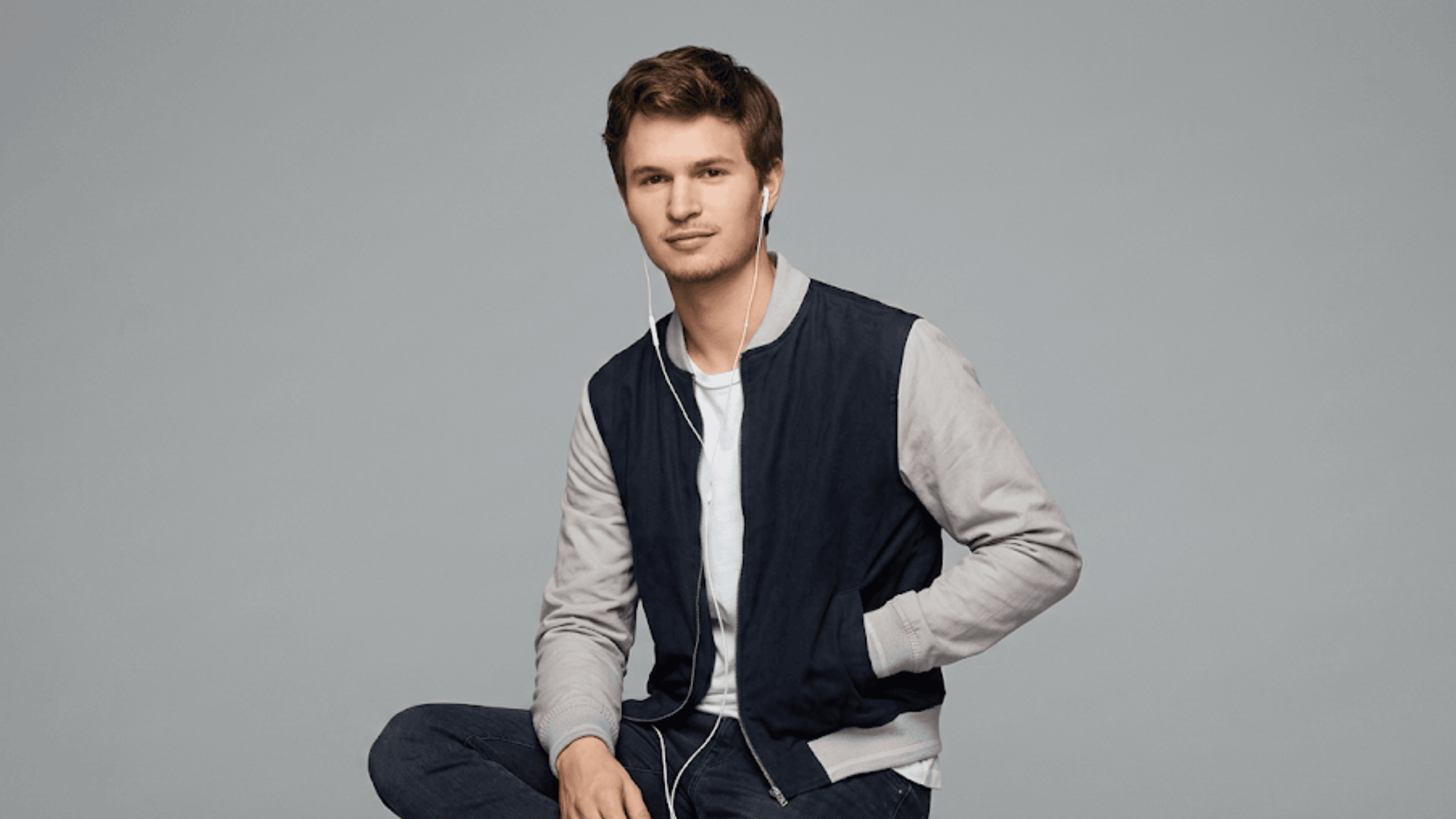 Ansel Elgort style varsity bomber jacket in a black and grey colorway featuring cotton fabric, rib-knitted cuffs, and a front zipper closure.