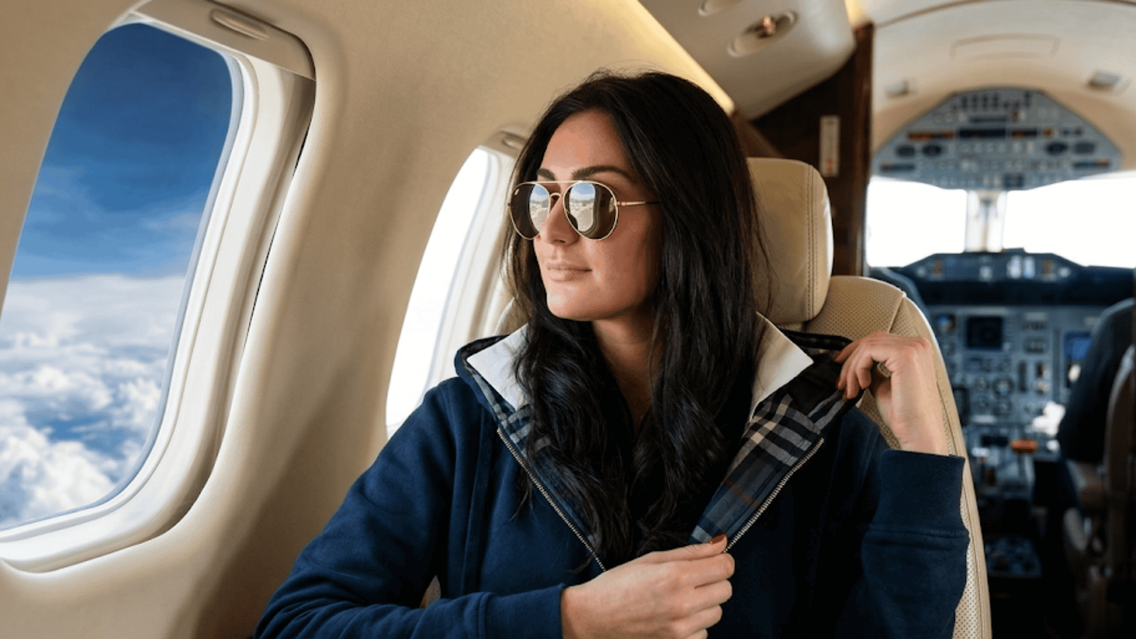 Jenni Farley wearing a navy blue wool blend bomber jacket featuring a distinctive shawl collar, plaid trim accents, and ribbed cuffs.